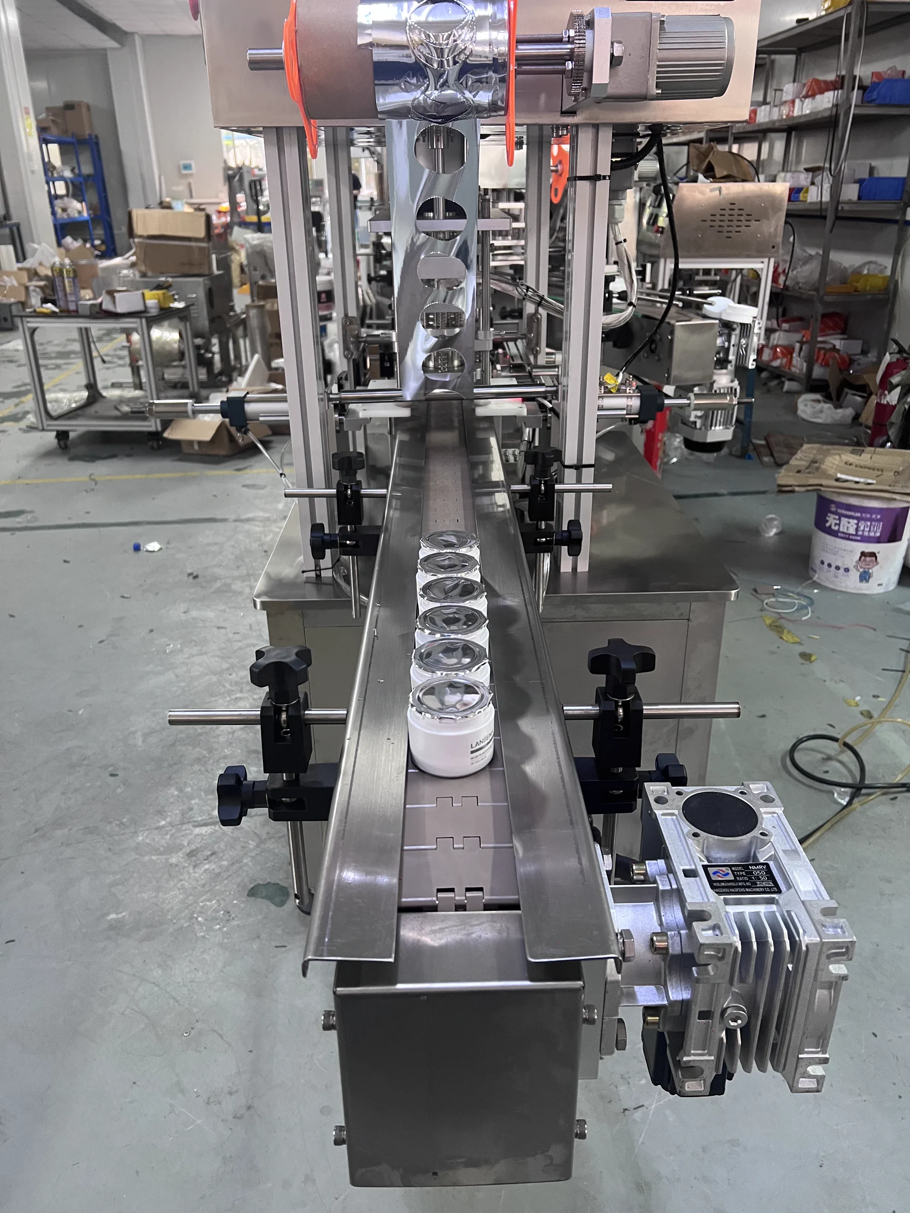 Bottle and Jar Inline Heat Press Sealer · Sealing process